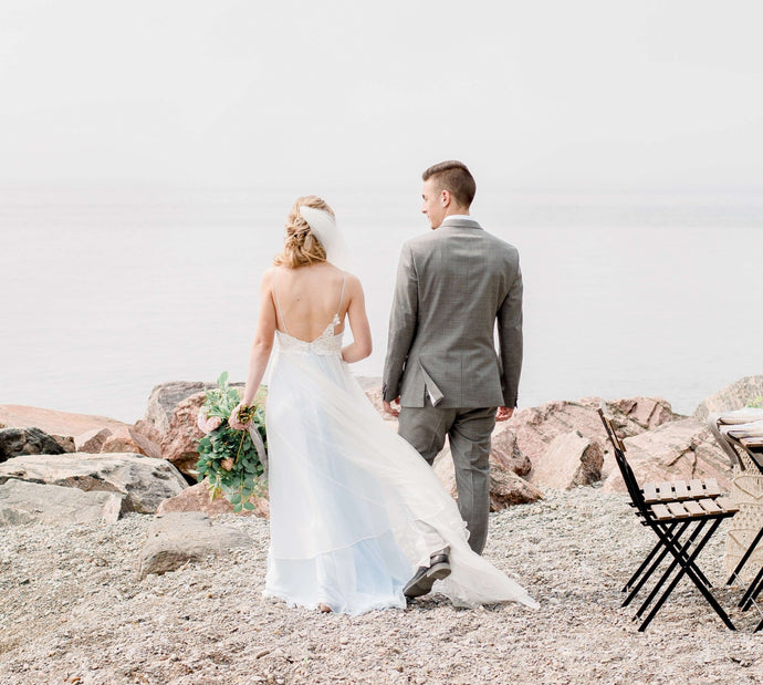 Bride and Groom walk on the beach Infinity Life Weddings